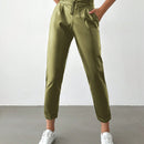 Pantalones largos de tela metalica con nudo frontal para mujer