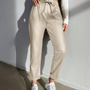 Pantalones largos de tela metalica con nudo frontal para mujer