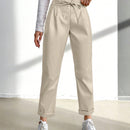 Pantalones largos de tela metalica con nudo frontal para mujer