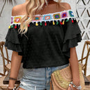 Blusa de hombros descubiertos con borlas en el borde