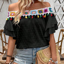 Blusa de hombros descubiertos con borlas en el borde
