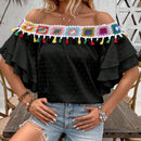 Blusa de hombros descubiertos con borlas en el borde