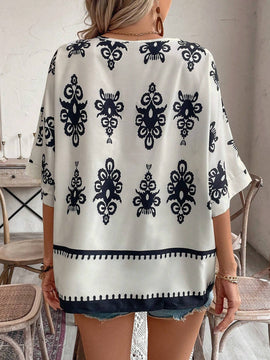 Camisa casual femenina con manga murcielago y cuello en V con estampado floral para vacaciones, patron aleatorio
