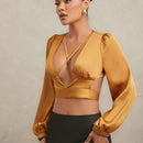 Blusa de cuello en V profundo y lazo trasero