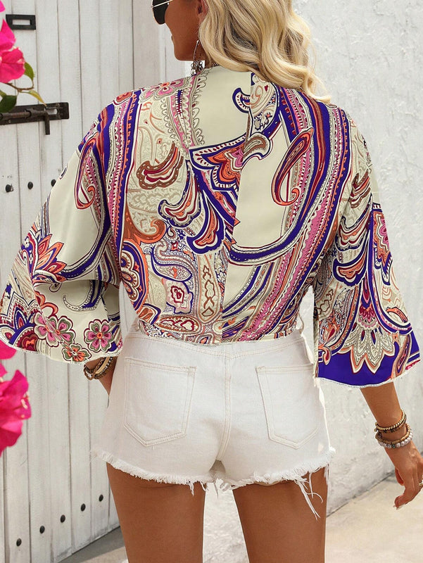 Blusa corta con manga acampanada y nudo delantero con estampado floral para vacaciones de mujer