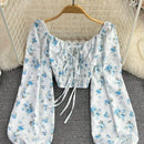 Blusa con estampado floral, manga de linterna y nudo delantero