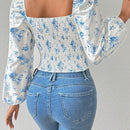 Blusa con estampado floral, manga de linterna y nudo delantero