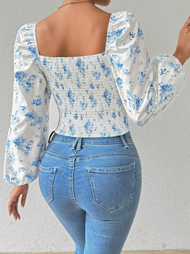 Blusa con estampado floral, manga de linterna y nudo delantero