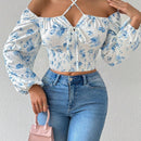 Blusa con estampado floral, manga de linterna y nudo delantero