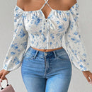 Blusa con estampado floral, manga de linterna y nudo delantero
