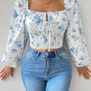Blusa con estampado floral, manga de linterna y nudo delantero