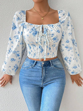 Blusa con estampado floral, manga de linterna y nudo delantero