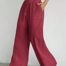 Pantalones sueltos de pierna ancha de color solido para mujer con dobladillo fluido, estilo casual
