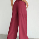 Pantalones sueltos de pierna ancha de color solido para mujer con dobladillo fluido, estilo casual