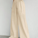 Pantalones sueltos de pierna ancha de color solido para mujer con dobladillo fluido, estilo casual