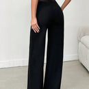 Tejido de lycra punto suelto negro, pantalon ancho cinturon elastico raya semitransparente y cintura en forma de v