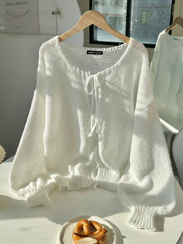 Frenchy cardigan de punto unicolor de color rosa palido con cinturon delantero, se puede usar sobre una camiseta