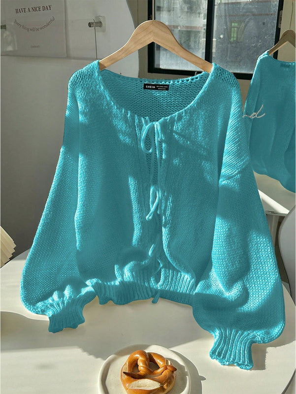 Frenchy cardigan de punto unicolor de color rosa palido con cinturon delantero, se puede usar sobre una camiseta