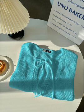 Frenchy cardigan de punto unicolor de color rosa palido con cinturon delantero, se puede usar sobre una camiseta