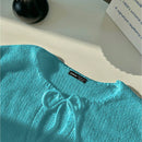 Frenchy cardigan de punto unicolor de color rosa palido con cinturon delantero, se puede usar sobre una camiseta