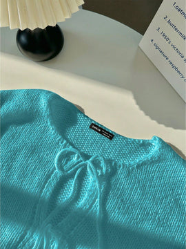 Frenchy cardigan de punto unicolor de color rosa palido con cinturon delantero, se puede usar sobre una camiseta