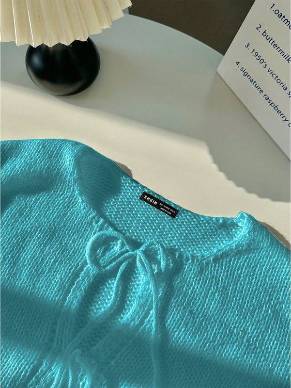 Frenchy cardigan de punto unicolor de color rosa palido con cinturon delantero, se puede usar sobre una camiseta