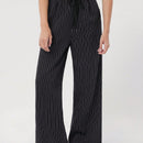 Pantalones sueltos de pierna ancha de color solido para mujer con dobladillo fluido, estilo casual
