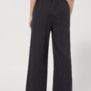 Pantalones sueltos de pierna ancha de color solido para mujer con dobladillo fluido, estilo casual