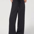 Pantalones sueltos de pierna ancha de color solido para mujer con dobladillo fluido, estilo casual