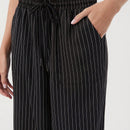 Pantalones sueltos de pierna ancha de color solido para mujer con dobladillo fluido, estilo casual
