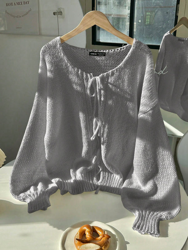 Frenchy cardigan de punto unicolor de color rosa palido con cinturon delantero, se puede usar sobre una camiseta