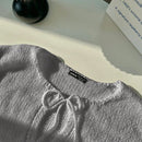 Frenchy cardigan de punto unicolor de color rosa palido con cinturon delantero, se puede usar sobre una camiseta