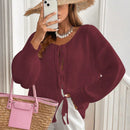 Frenchy cardigan de punto unicolor de color rosa palido con cinturon delantero, se puede usar sobre una camiseta