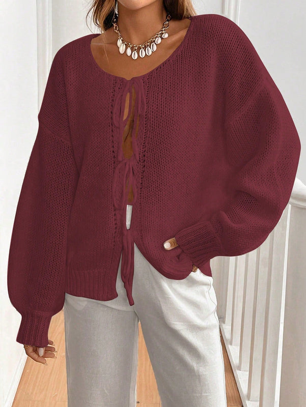 Frenchy cardigan de punto unicolor de color rosa palido con cinturon delantero, se puede usar sobre una camiseta