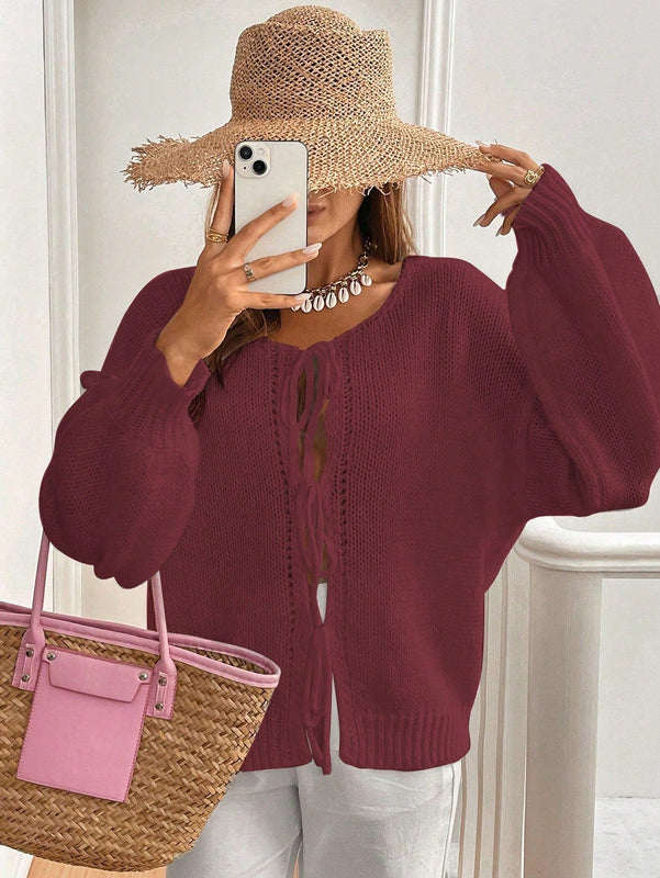 Frenchy cardigan de punto unicolor de color rosa palido con cinturon delantero, se puede usar sobre una camiseta