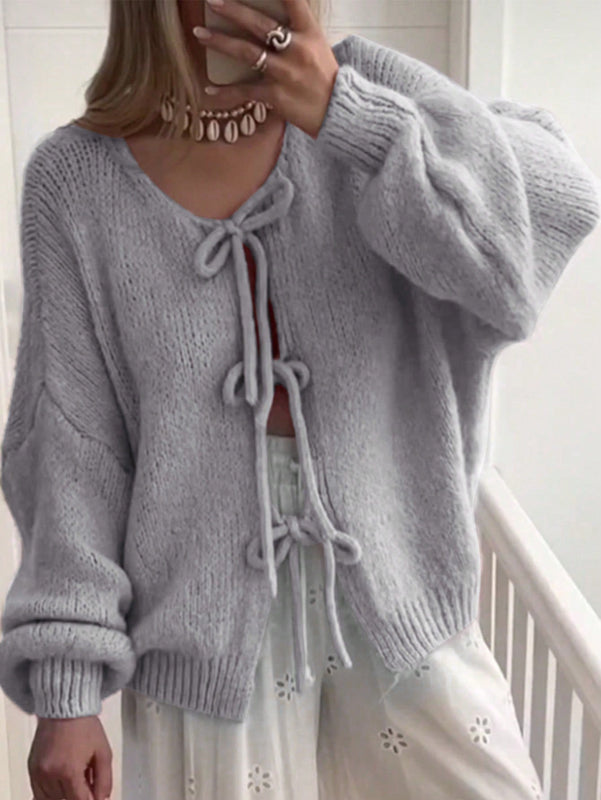 Frenchy cardigan de punto unicolor de color rosa palido con cinturon delantero, se puede usar sobre una camiseta