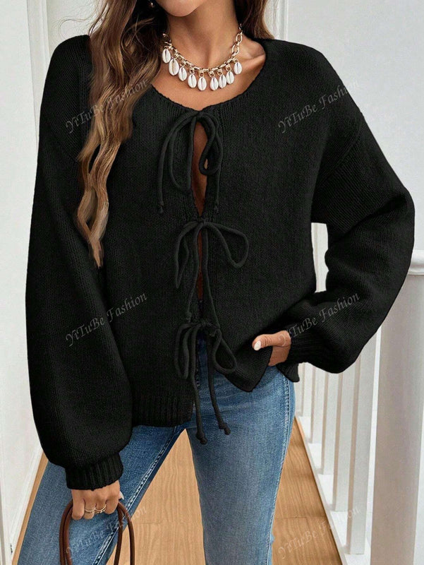 Cardigan de punto de color liso con detalle de nudo delantero, de estilo minimalista para uso en la oficina, atemporal y femenino. cardigan de punto en un solo color con abertura frontal que se puede usar sobre blusas, un cardigan oversize y adorable