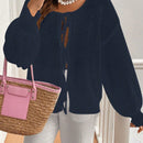 Frenchy cardigan de punto unicolor de color rosa palido con cinturon delantero, se puede usar sobre una camiseta