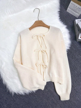 Cardigan de punto de color liso con detalle de nudo delantero, de estilo minimalista para uso en la oficina, atemporal y femenino. cardigan de punto en un solo color con abertura frontal que se puede usar sobre blusas, un cardigan oversize y adorable
