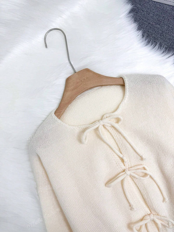 Cardigan de punto de color liso con detalle de nudo delantero, de estilo minimalista para uso en la oficina, atemporal y femenino. cardigan de punto en un solo color con abertura frontal que se puede usar sobre blusas, un cardigan oversize y adorable