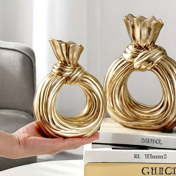 Una botella decorativa de resina, ideal para decoración de hogar contemporáneo, un jarrón minimalista nórdico bohemio para flores de pampa, con un diseño distintivo de lazo, apto para uso como jarrón o como regalo decorativo.