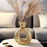 Una botella decorativa de resina, ideal para decoración de hogar contemporáneo, un jarrón minimalista nórdico bohemio para flores de pampa, con un diseño distintivo de lazo, apto para uso como jarrón o como regalo decorativo.