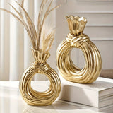 Una botella decorativa de resina, ideal para decoración de hogar contemporáneo, un jarrón minimalista nórdico bohemio para flores de pampa, con un diseño distintivo de lazo, apto para uso como jarrón o como regalo decorativo.