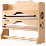 Un cortador de plástico de cocina con soporte para papel toalla, hecho de bambú, sirve como estante de almacenamiento para papel de cocina y papel de aluminio, con dos compartimentos para cortar.